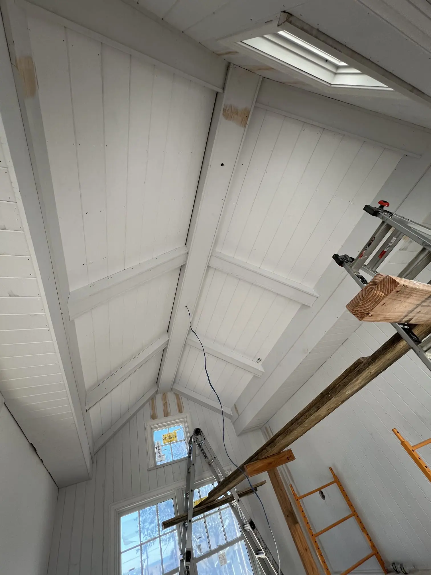 Vaulted ceiling build in progress with trim and panel detail.